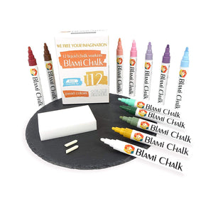 a group of colorful markers and a box of chalk with text: 'www WE FREE YOUR IMAGINATION 12 liquid CHALK MARKERS BLAMi CHALK BLAMi CHALK BLAMi BLAMi BLAMi CHALK BLAMi 112 6mm BLAMi CHALK reversible tip PASTEL COLORS + BLAMI ERASER BlAMi CHALK BLAMi CHALK BlAMi CHALK CHALK BLAMi CHALK'