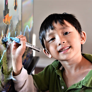 a child drawing on a canvas with text: 'CHALK'