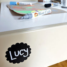 a white table with a black marker on it with text: 'Lucy'