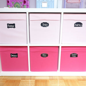 a shelf with pink boxes with text: 'BARBIE BAB ANIMALS SOFT PLASTIC DRESSES TOYS TOYS'
