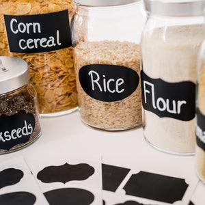 a group of jars with labels on them with text: 'Corn cereal Rice Flour seeds'