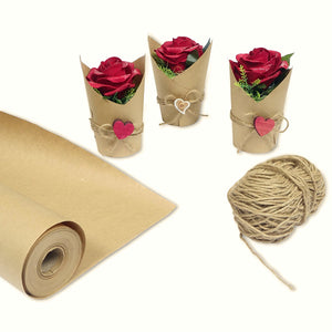 a roll of brown paper with red roses and a ball of string